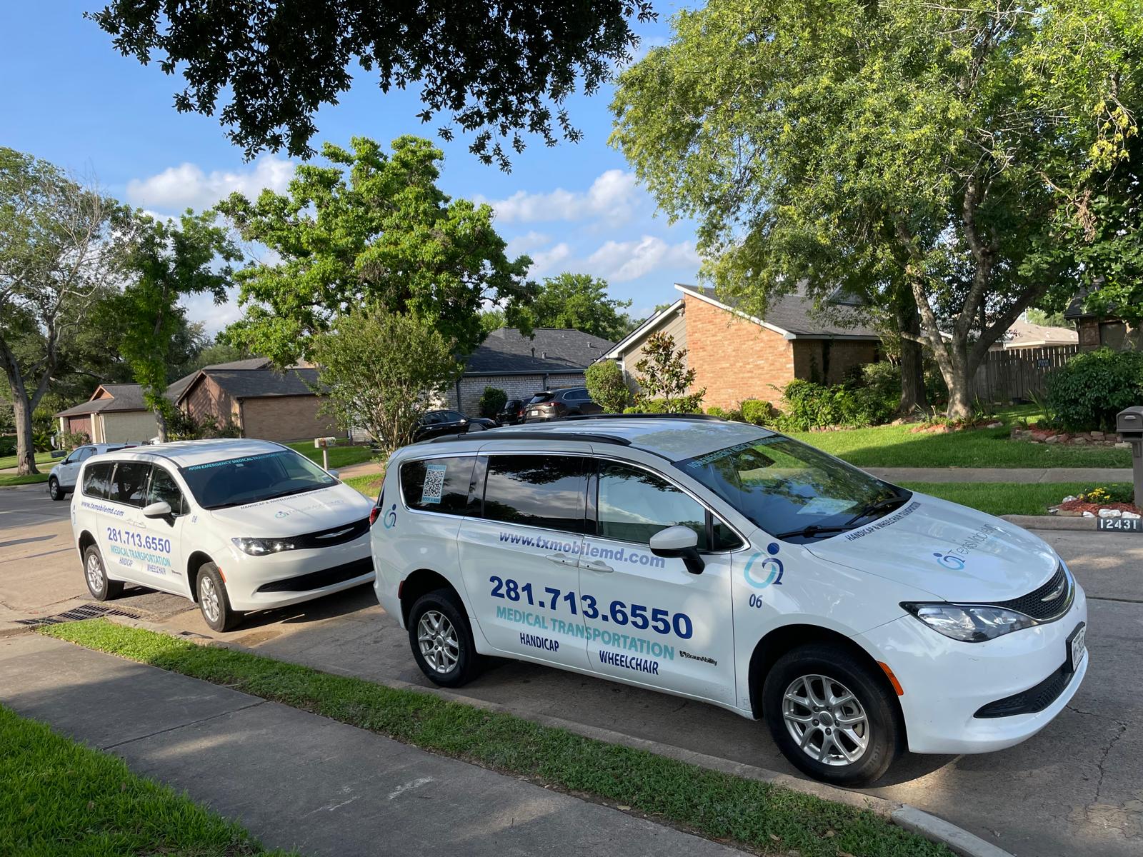 Two Texas Mobile MD transportation vans parked outside a home