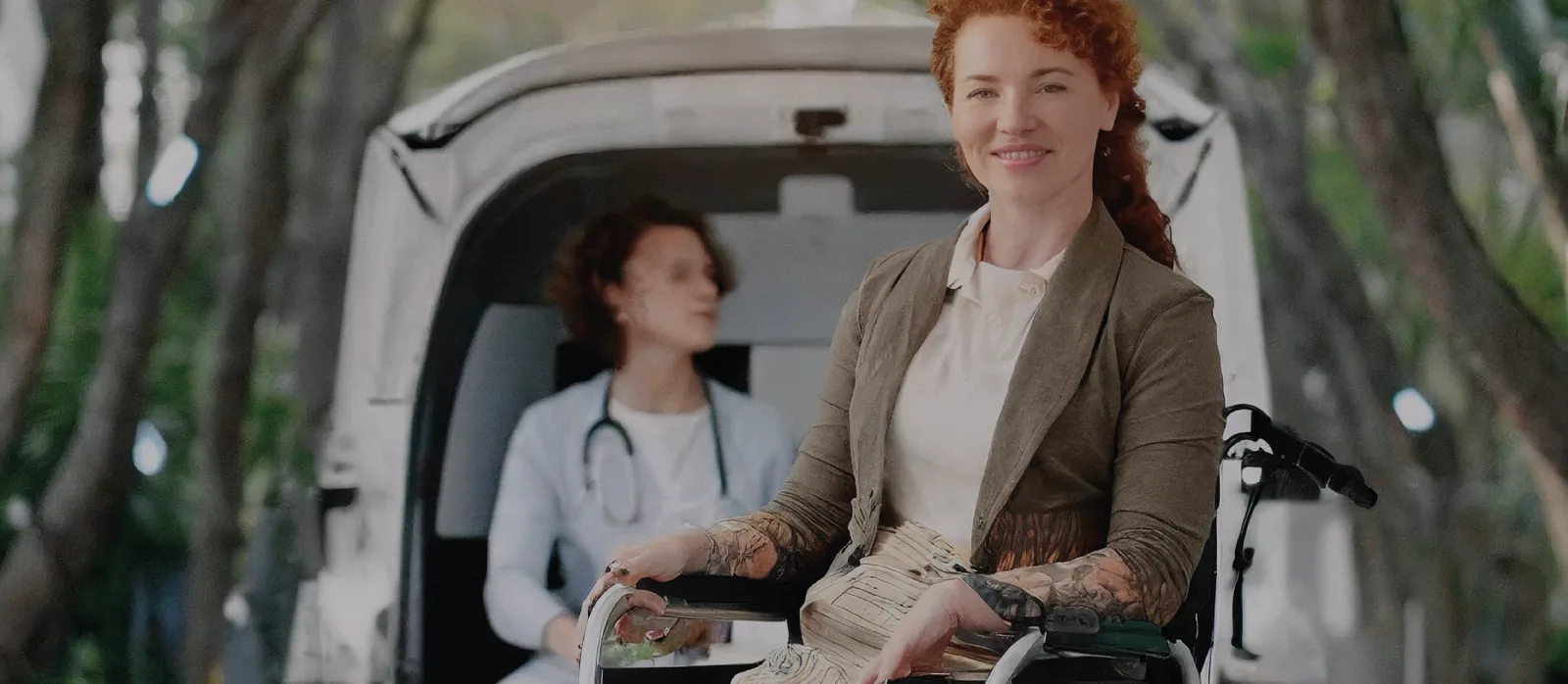 Patient in front of medical transport van
